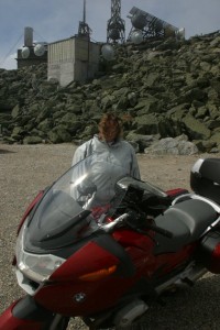 Amy at Mt Washington summit Nobody told Amy it was windy at Mt Washington.